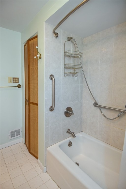 bathroom featuring tiled shower / bath combo and tile patterned flooring