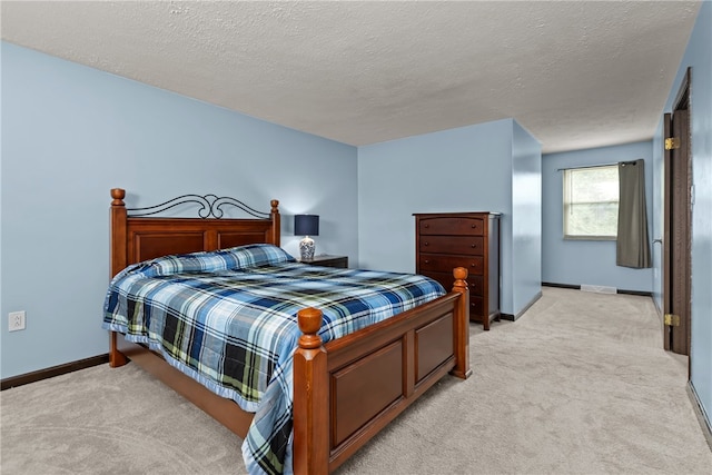 carpeted bedroom featuring a textured ceiling