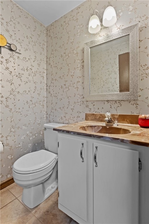 bathroom featuring tile patterned floors, toilet, and vanity