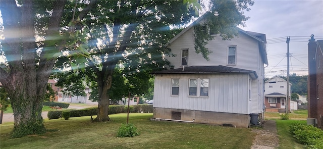 view of side of home featuring a lawn