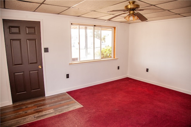 foyer with a paneled ceiling, ceiling fan, and carpet floors