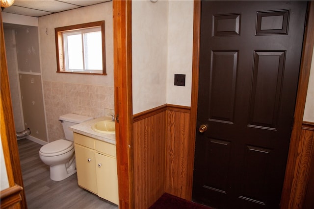 bathroom with vanity, toilet, a paneled ceiling, and hardwood / wood-style floors