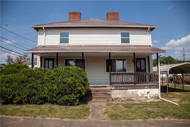 farmhouse with covered porch and a carport