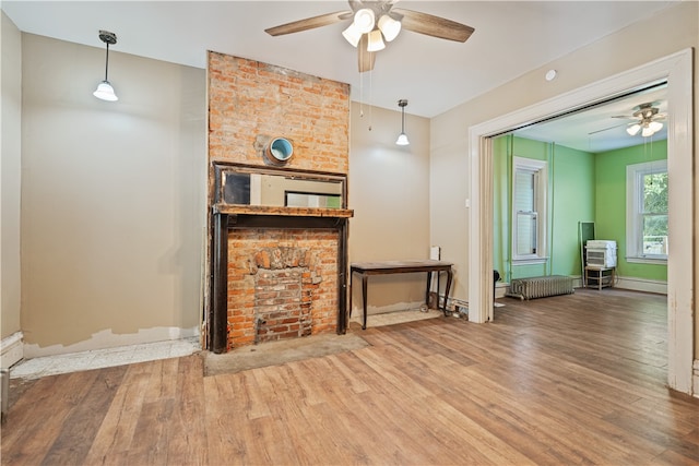 living room with ceiling fan and wood finished floors