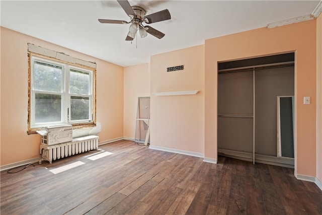 unfurnished bedroom featuring a closet, wood finished floors, and baseboards