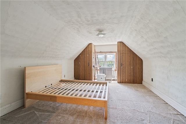 bonus room with carpet flooring, vaulted ceiling, a textured ceiling, and baseboards