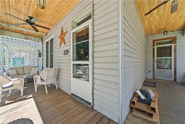 deck with ceiling fan and an outdoor living space