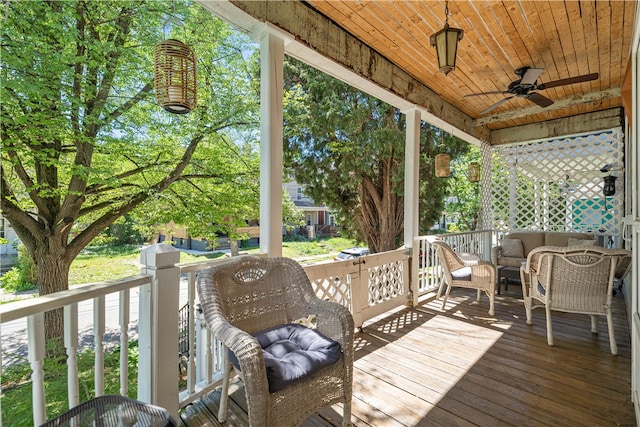 wooden deck featuring ceiling fan and outdoor lounge area