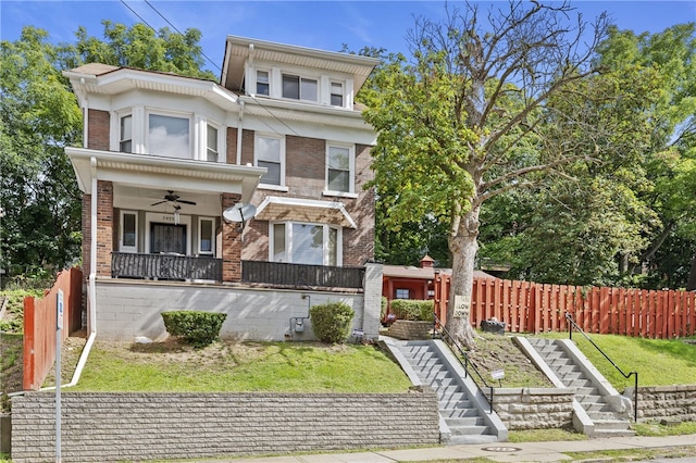 view of front of property with a front lawn and ceiling fan