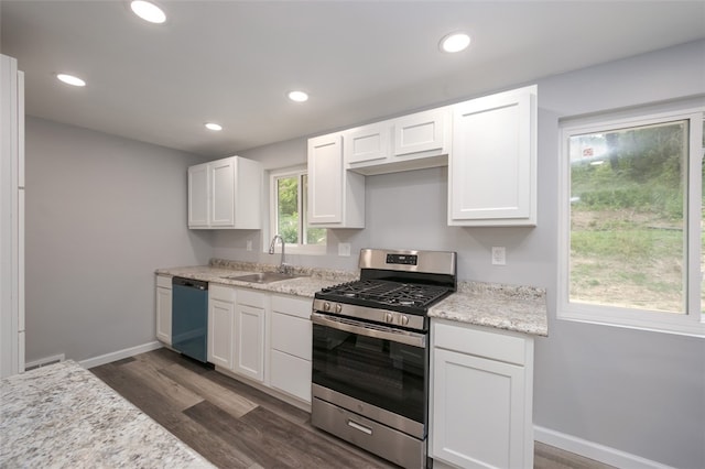 kitchen featuring sink, white cabinetry, appliances with stainless steel finishes, dark hardwood / wood-style flooring, and light stone countertops