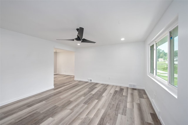 unfurnished room with light wood-type flooring and ceiling fan