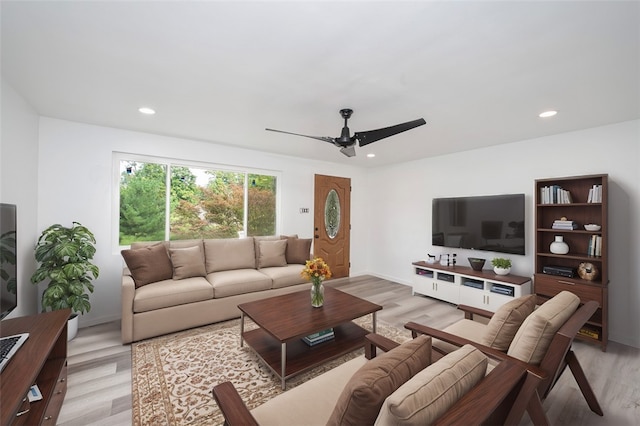 living room with ceiling fan and light wood-type flooring