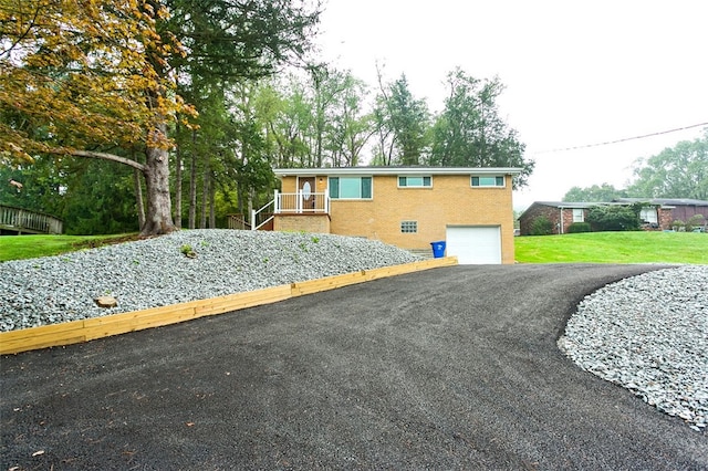 view of front of home with a front yard and a garage