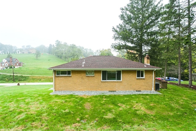 view of home's exterior with a yard and central AC