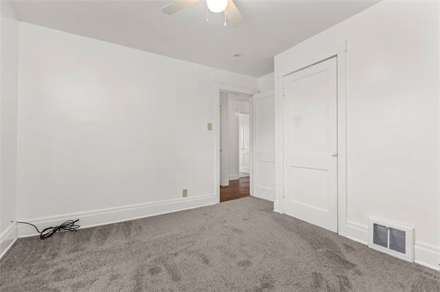 unfurnished bedroom featuring a closet, ceiling fan, and carpet floors