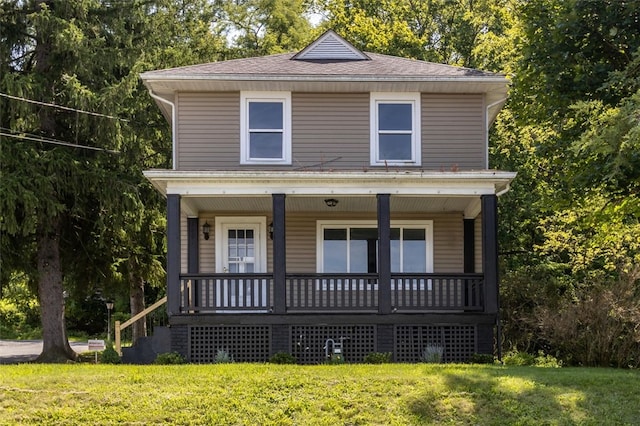 view of front property with covered porch and a front lawn