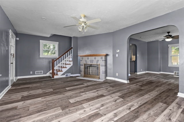 interior space with ceiling fan, hardwood / wood-style flooring, and a fireplace