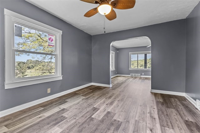 unfurnished room featuring ceiling fan and hardwood / wood-style flooring