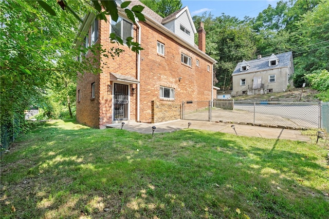 exterior space featuring a lawn and a patio