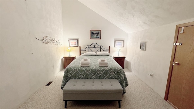 carpeted bedroom with vaulted ceiling