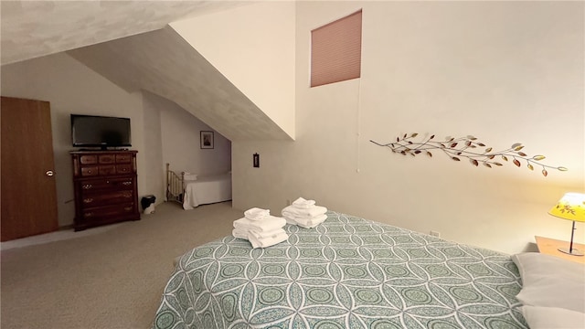 bedroom with light carpet and lofted ceiling