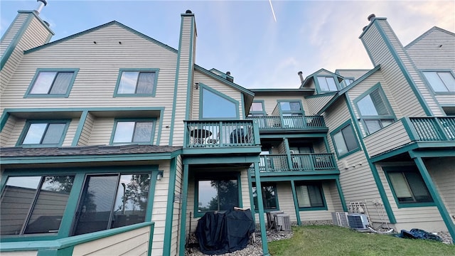 rear view of property featuring a balcony