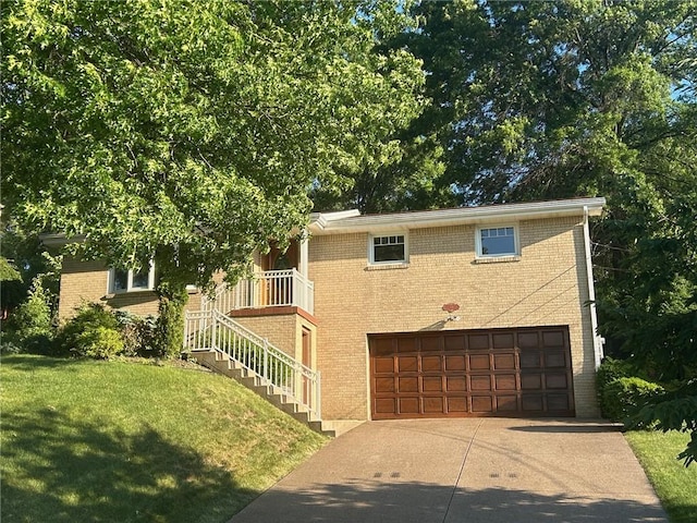 view of front facade with a garage, driveway, brick siding, and a front lawn