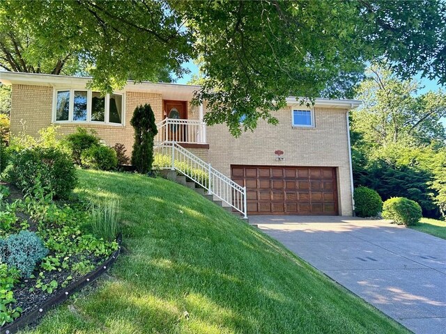 view of front of home featuring a garage and a front lawn