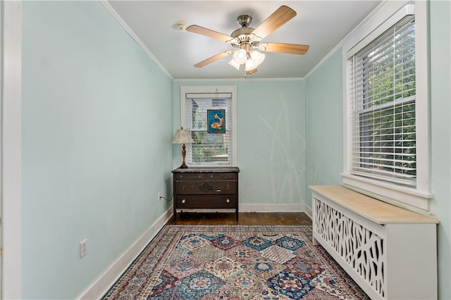 interior space with ceiling fan, crown molding, and dark hardwood / wood-style flooring