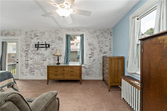 carpeted bedroom featuring ceiling fan and multiple windows