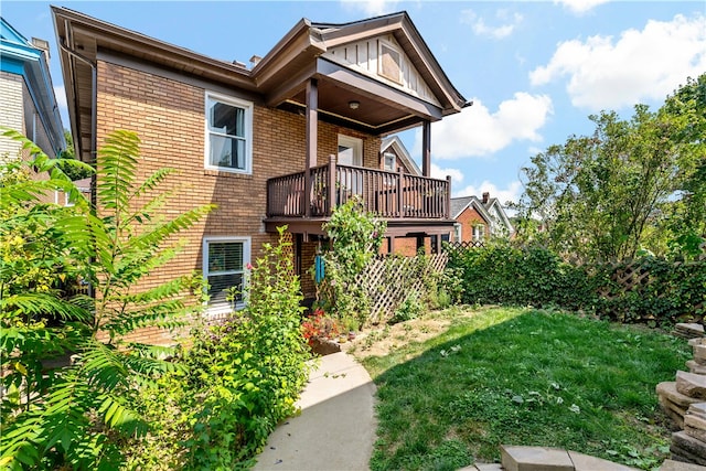 rear view of property featuring a yard