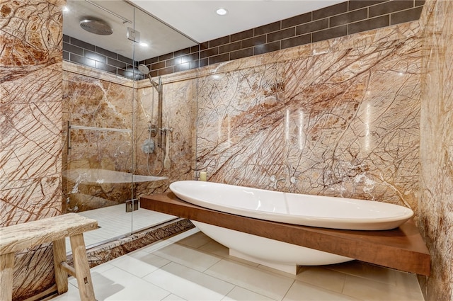 bathroom featuring tile walls, tile patterned floors, and plus walk in shower