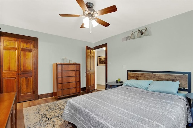 bedroom with ceiling fan and light hardwood / wood-style floors