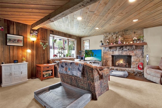 living room featuring light carpet, a fireplace, wooden walls, wooden ceiling, and beamed ceiling