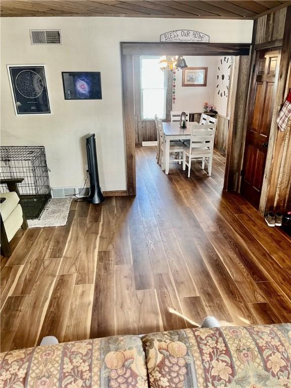 interior space with wood ceiling, dark hardwood / wood-style floors, and an inviting chandelier