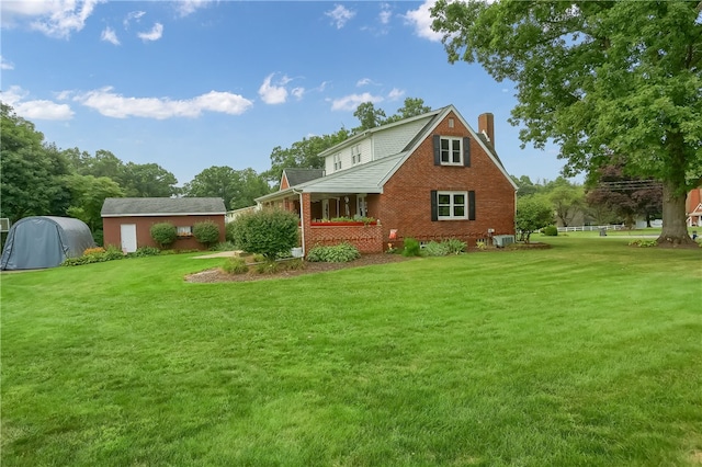 exterior space featuring central AC unit and a lawn