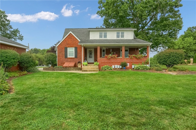 view of front of house with covered porch and a front yard