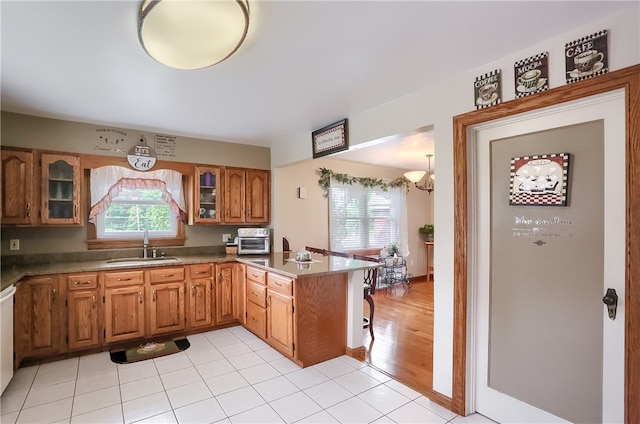 kitchen with plenty of natural light, light tile patterned floors, and sink