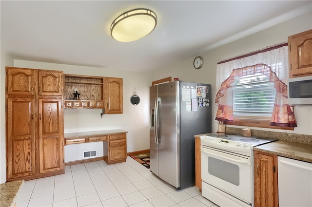 kitchen with white appliances and light tile patterned flooring