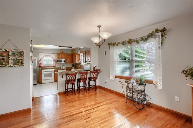 dining space with a chandelier, sink, and light tile patterned flooring