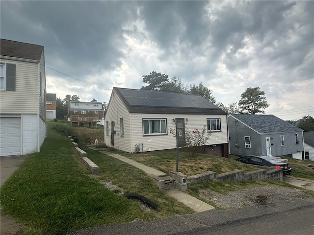 view of front of home with solar panels and a garage