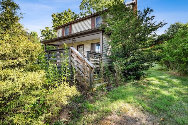 rear view of property with a wooden deck