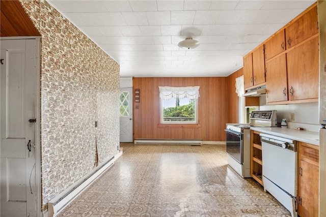 kitchen featuring a baseboard radiator, wood walls, light tile patterned floors, and white appliances