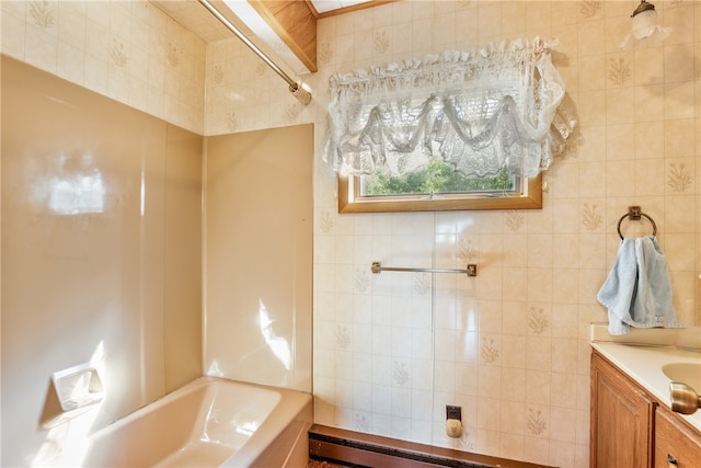 bathroom featuring vanity, tile walls, and washtub / shower combination