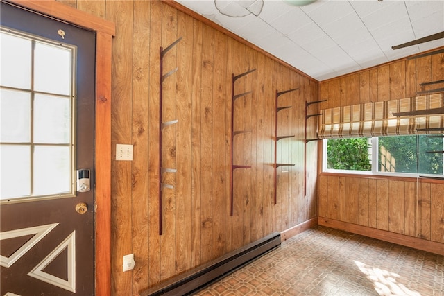 interior space featuring a baseboard heating unit, wooden walls, and tile patterned flooring