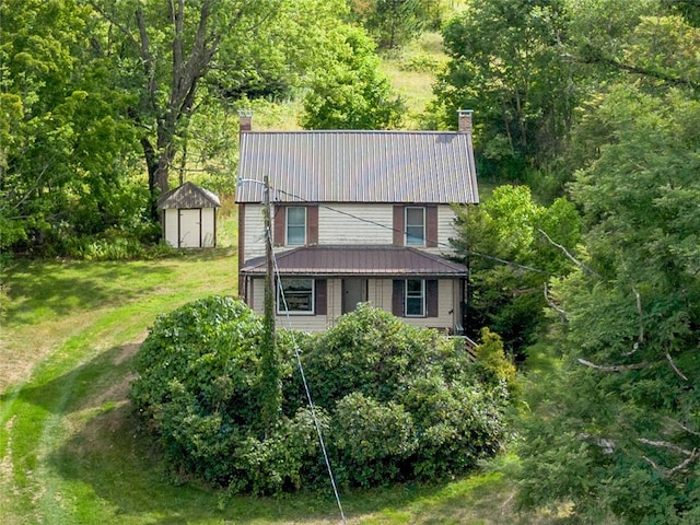 view of front of house featuring a storage unit