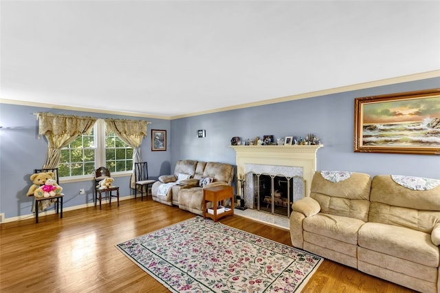 living room with a high end fireplace, hardwood / wood-style flooring, and crown molding