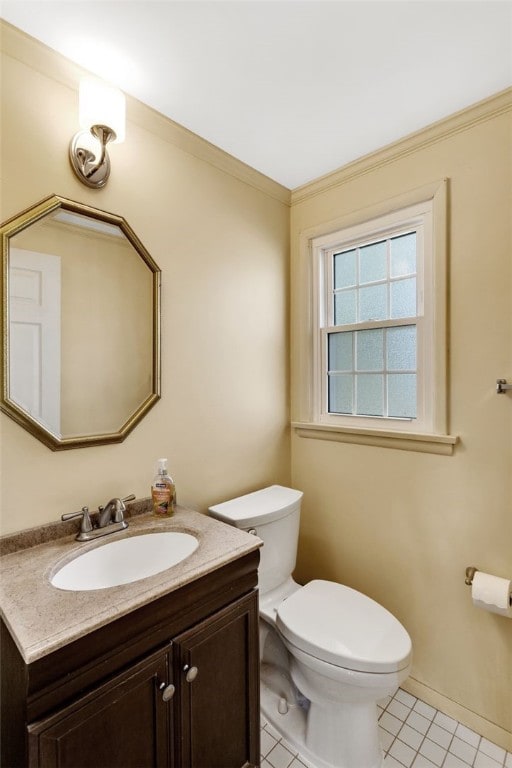 bathroom with tile patterned floors, vanity, ornamental molding, and toilet