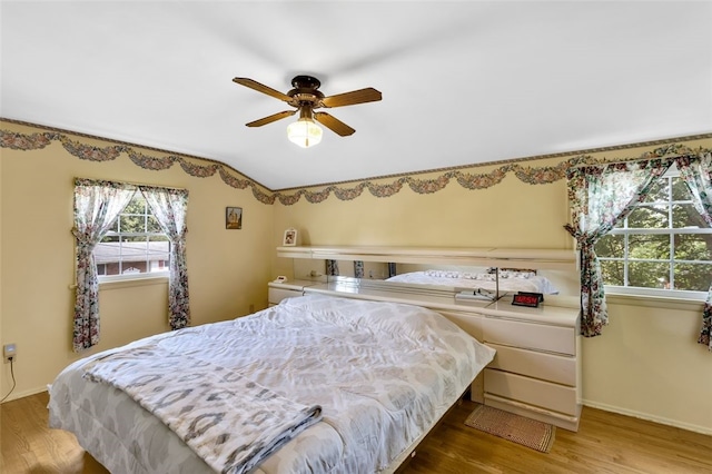 bedroom with ceiling fan and hardwood / wood-style floors