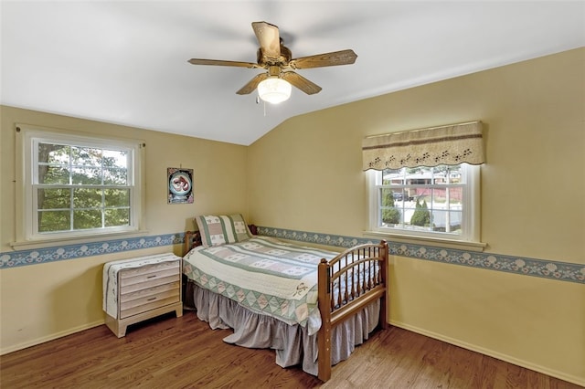 bedroom with hardwood / wood-style flooring, ceiling fan, and vaulted ceiling